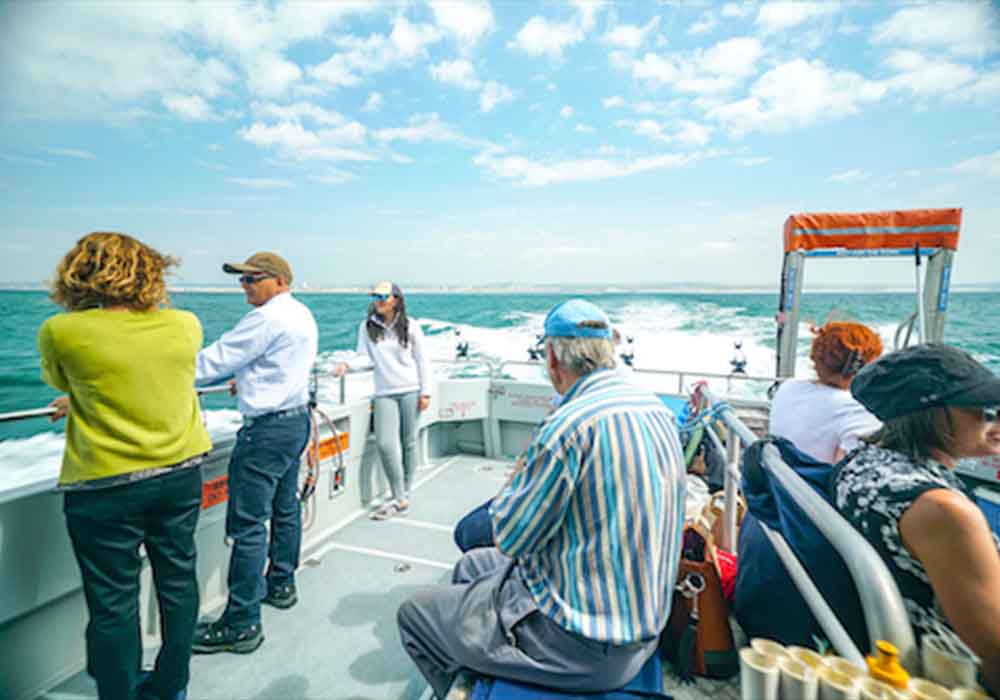 People stood chatting on a boat