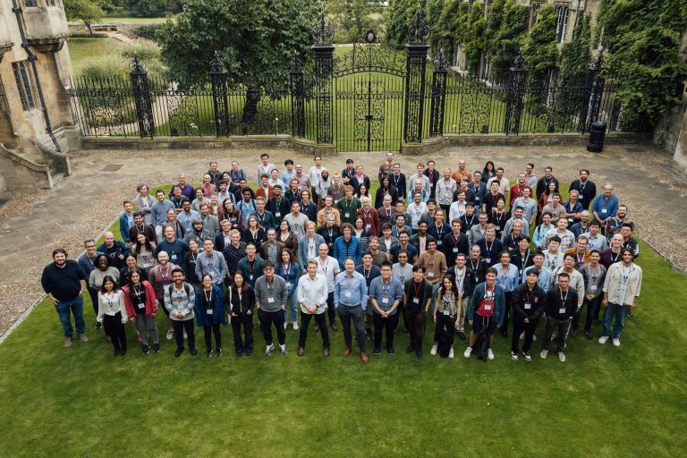 Event attendees pose for photo on lawn