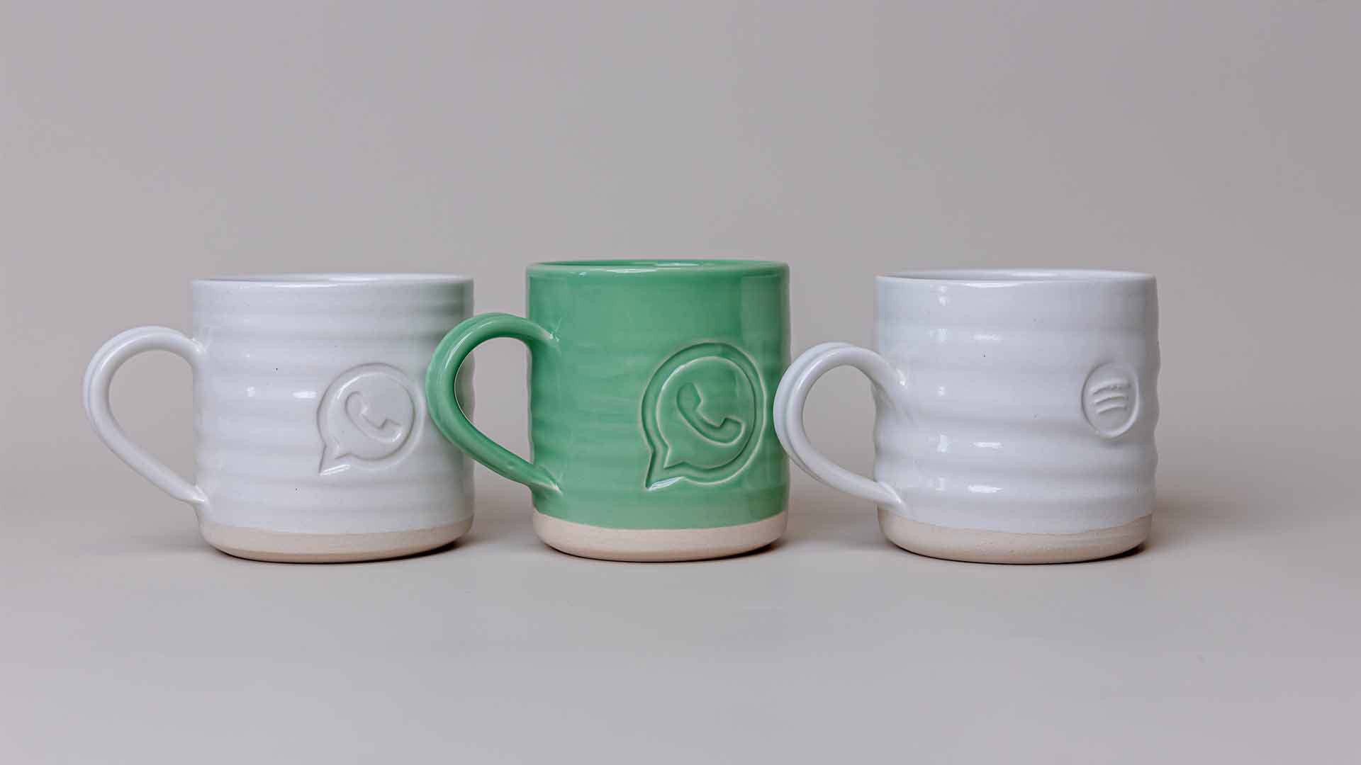 Mugs in a line with Whatsapp logo