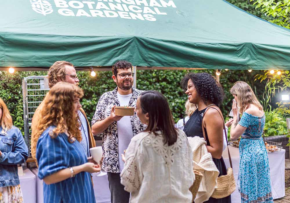 Group of people smiling in conversation at event
